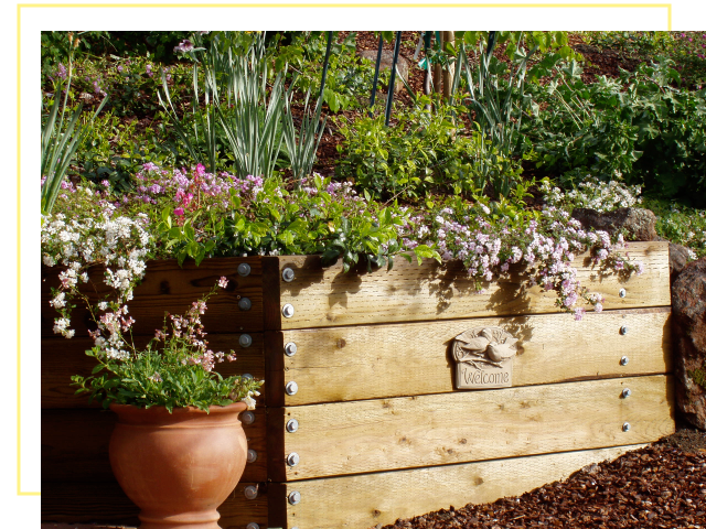A planter sitting on top of a wooden fence.