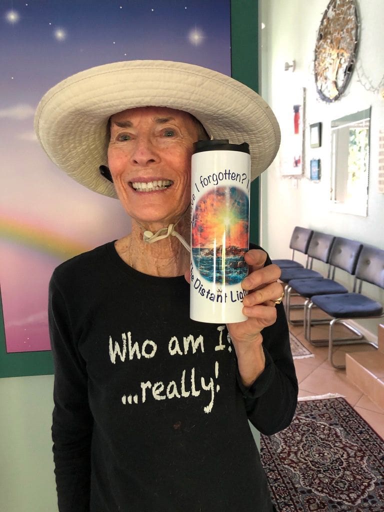 A woman holding up a cup with the words " who am i really ?" on it.